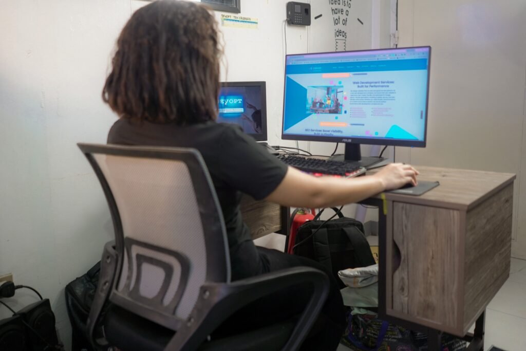 SEO specialist working on a website at a desktop computer.